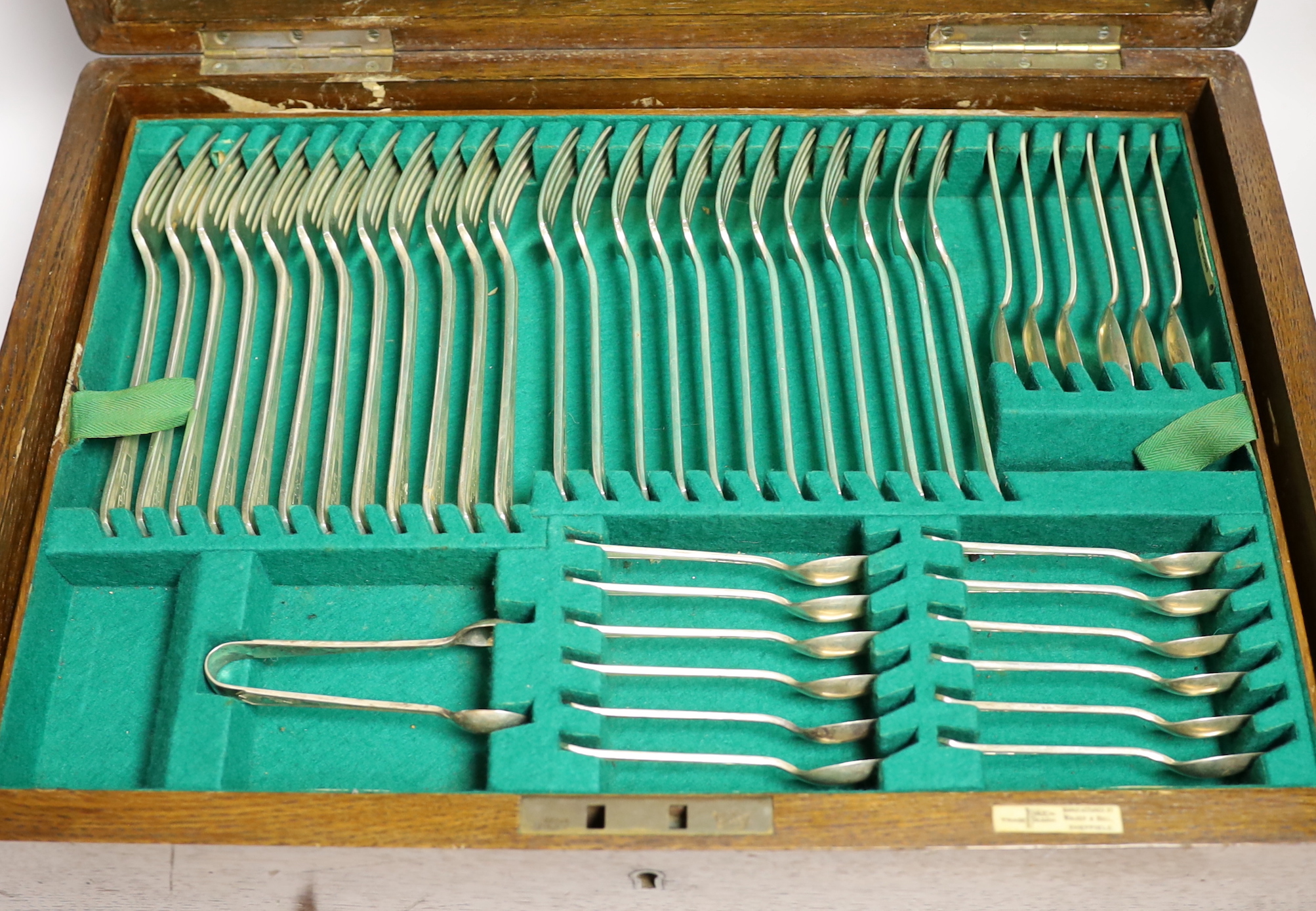 An almost complete George VI Art Deco silver canteen of cutlery by Walker & Hall comprising seventy five items, 119.6oz, together with eleven ivorine handled table knives and twelve dessert knives (two with replaced hand